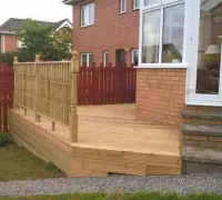 Finished garden decking beside conservatory