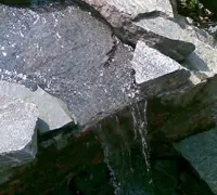 small waterfall into pond